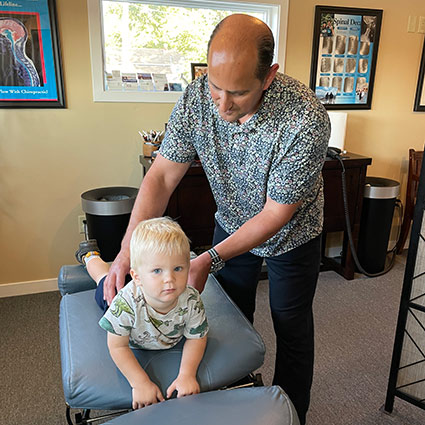 chiropractor adjusting child