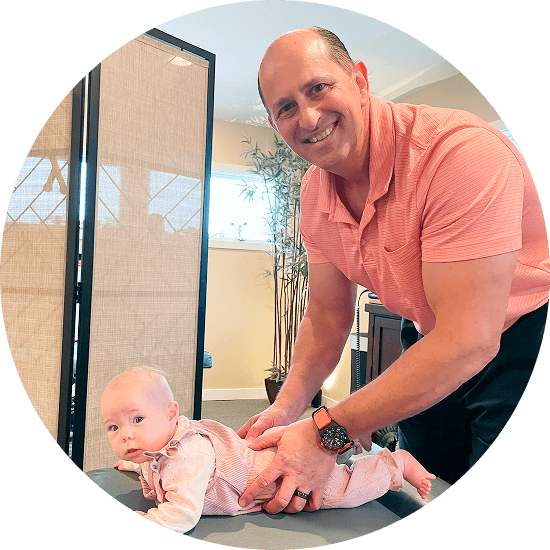 Chiropractor adjusting baby