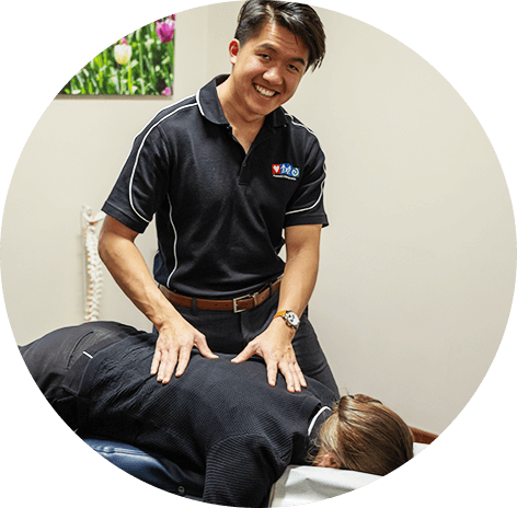 Dr Ken Win Kok, Chiropractor adjusting patient