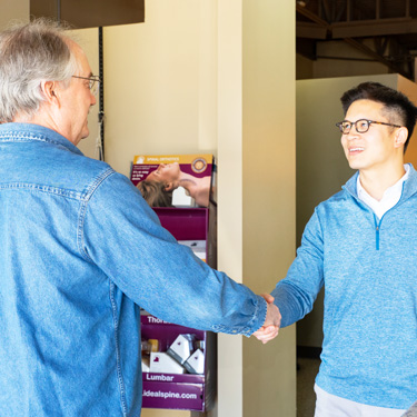 Dr. Tran shaking patients hand