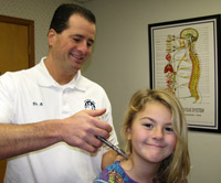 Dr. Ancone using the activator method on his patient