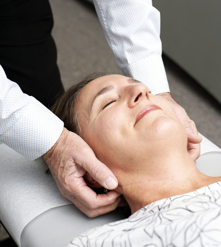 woman having neck adjusted