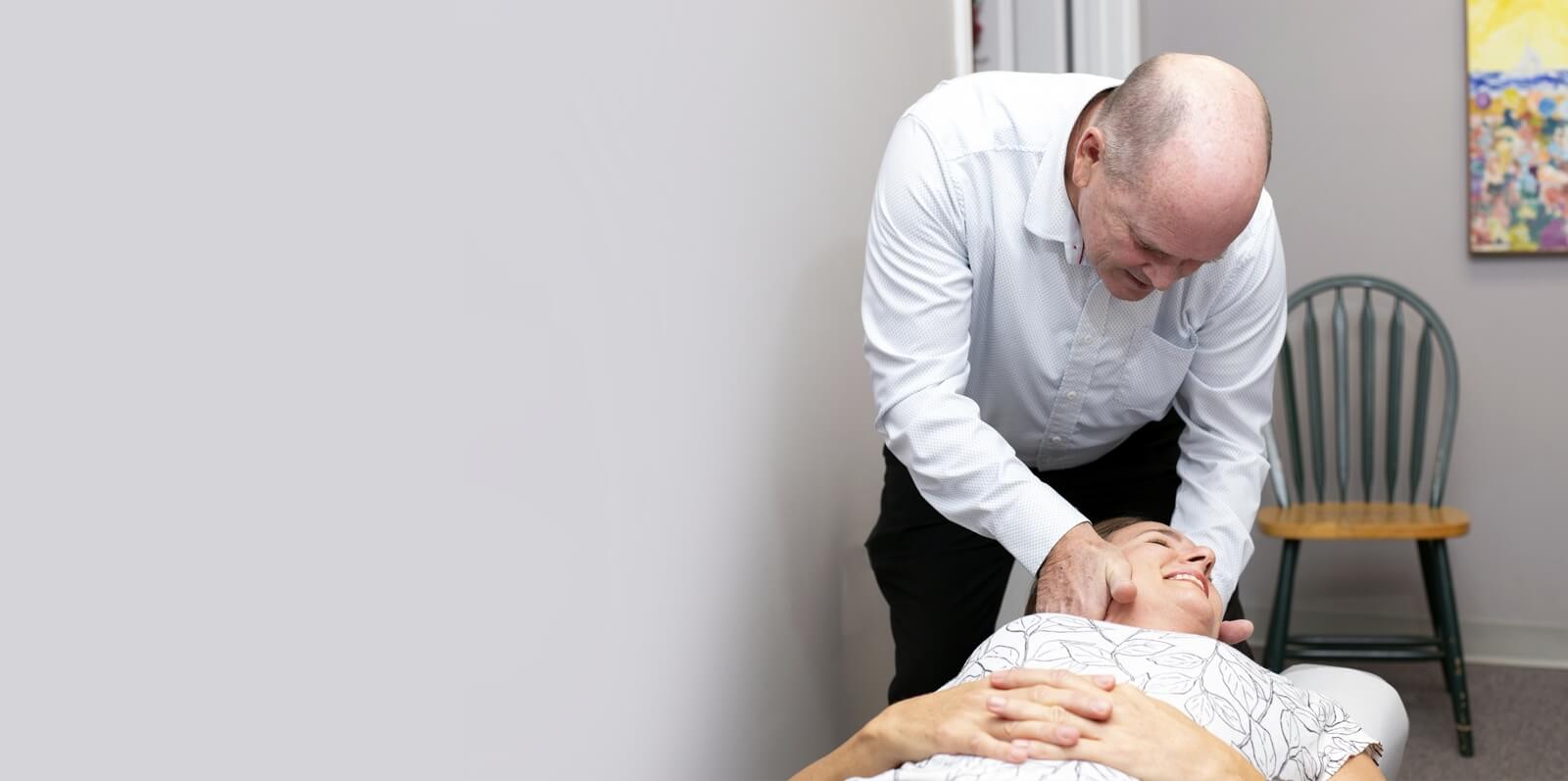 Prince Frederick chiropractor Dr Collins adjusting patients neck