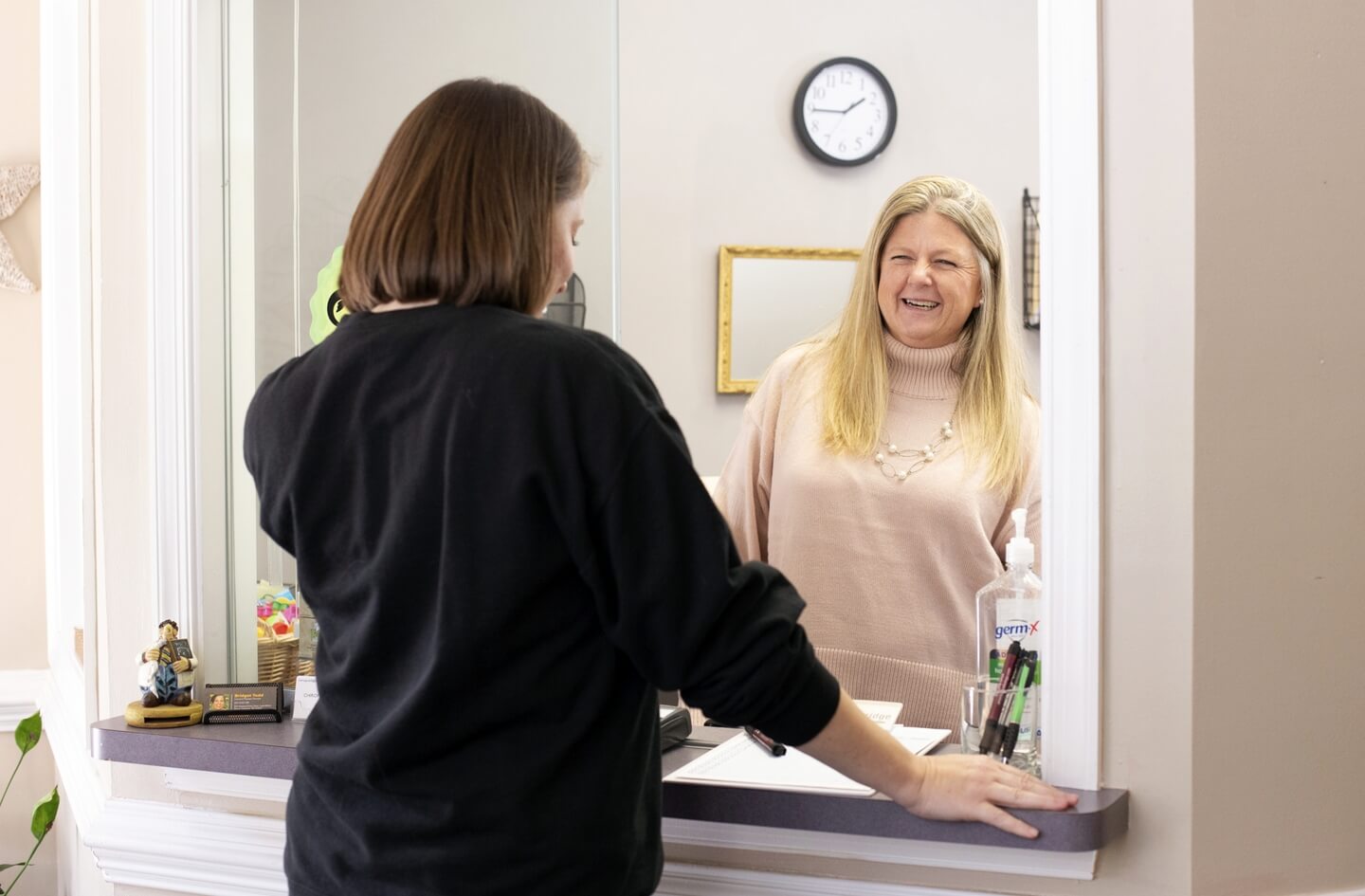 patient at the Collins Chiropractic Center front desk