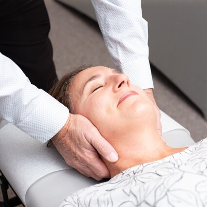 Dr Collins adjusting patients neck