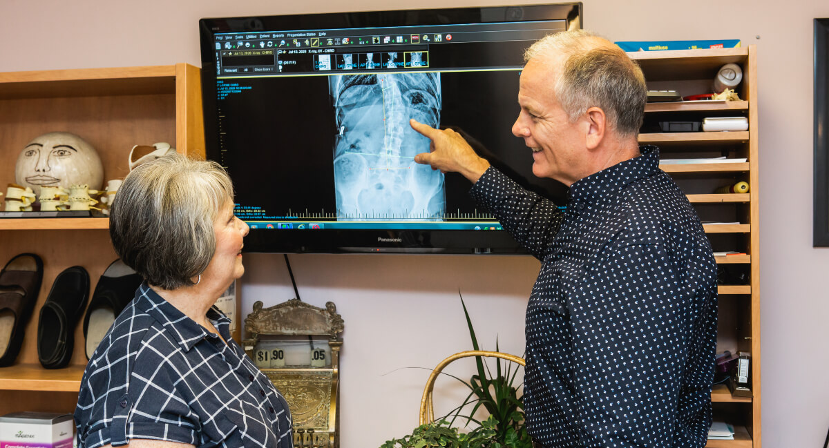 Chiropractor discussing x-rays with patient