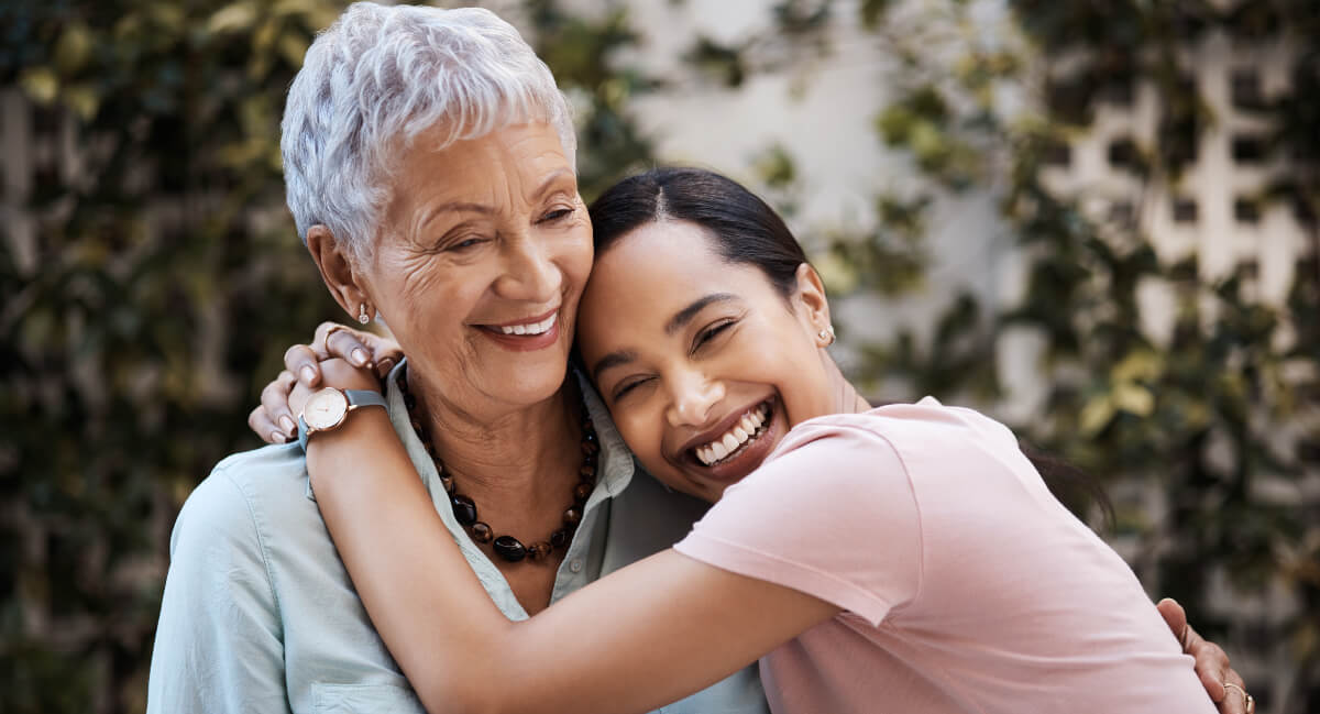 Two women hugging and laughing