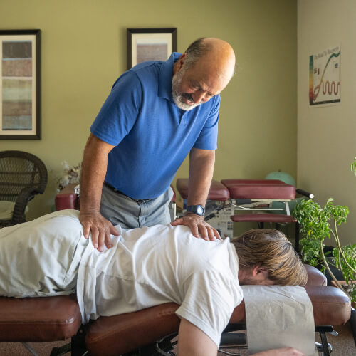 Female patient receiving adjustment from a chiropractor