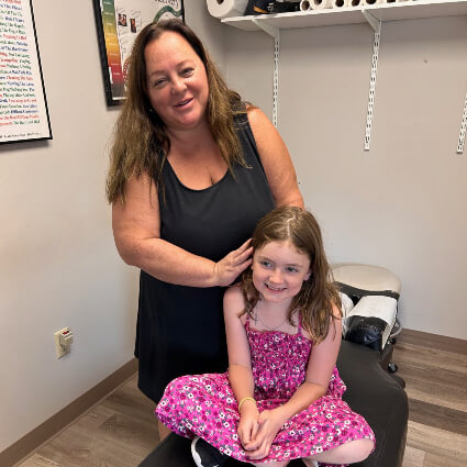 Weymouth Chiropractor Dr. Diane Capone adjusting girl on table