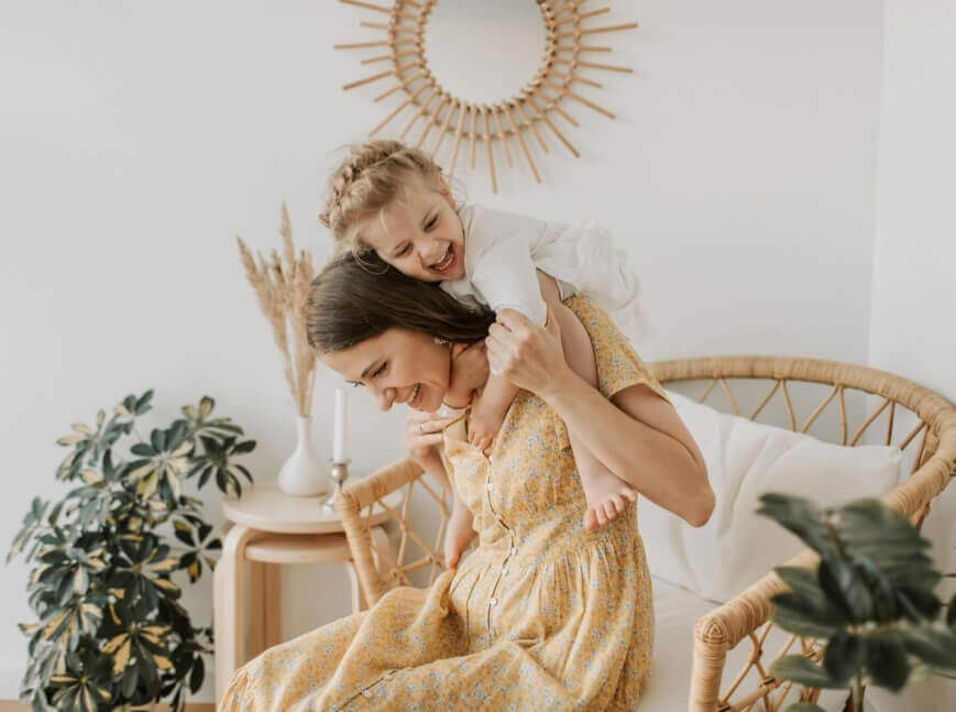 mom and daughter playing and laughing