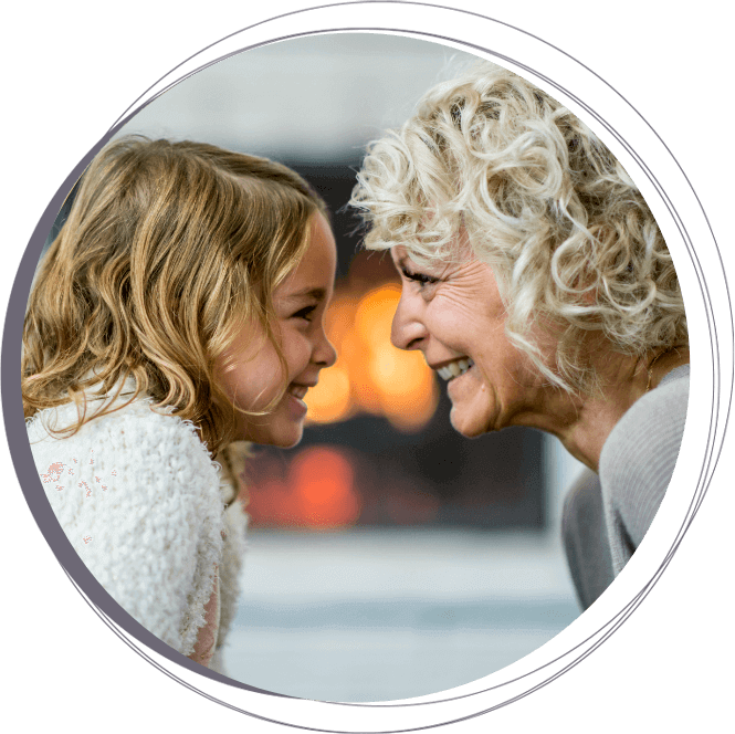 grandmother and granddaughter smiling at each other