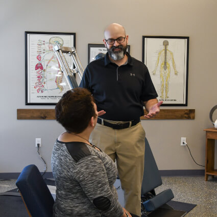 Espanola Chiropractor Dr. John Fox talking to patient