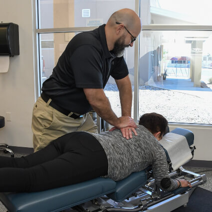 adjusting woman's back