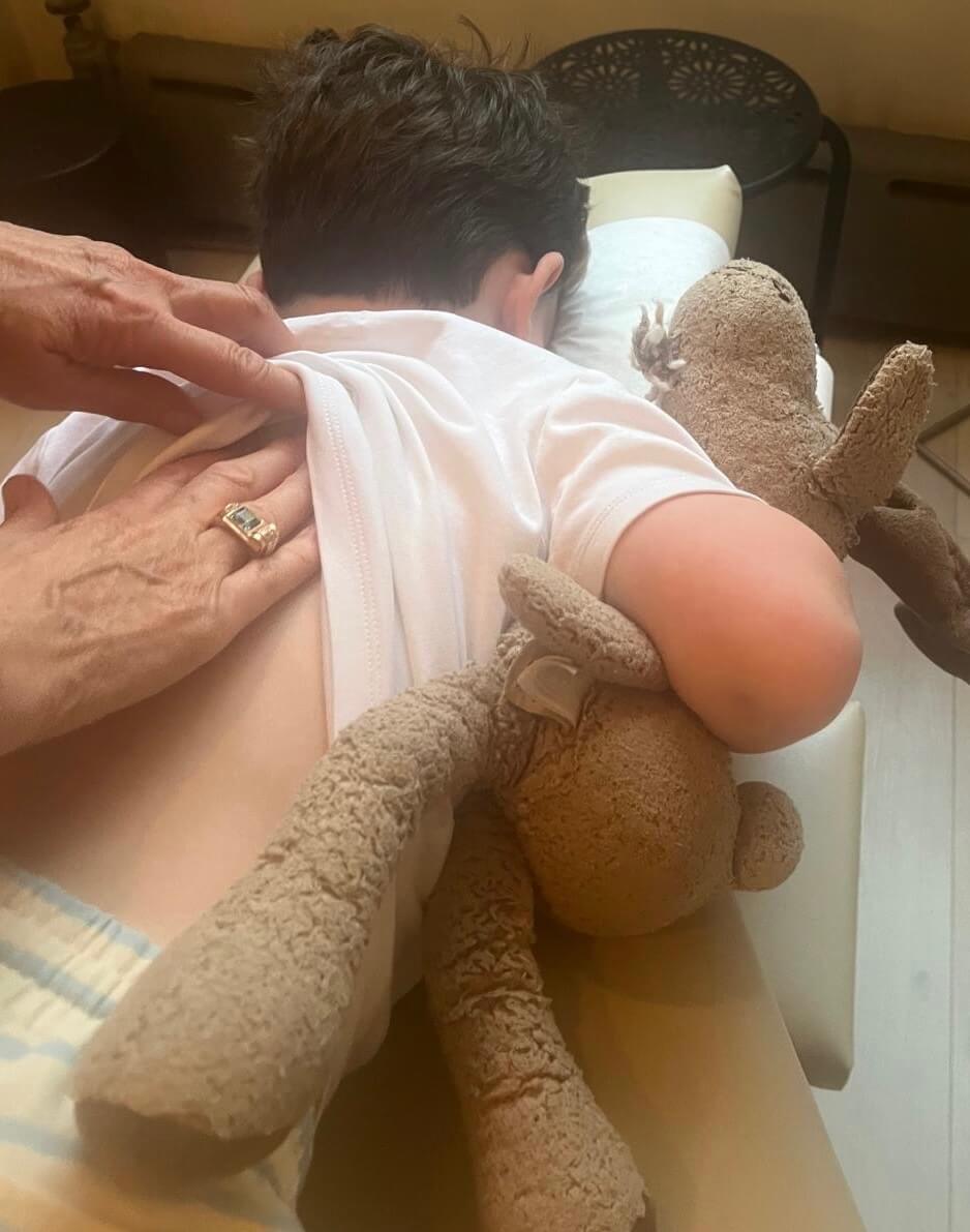 Chiropractic adjustment of child on table