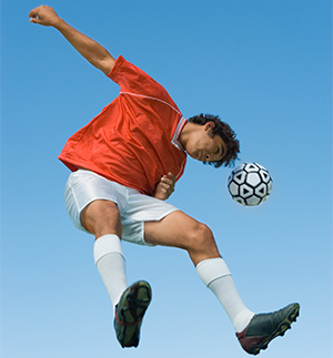 Soccer player heads the ball