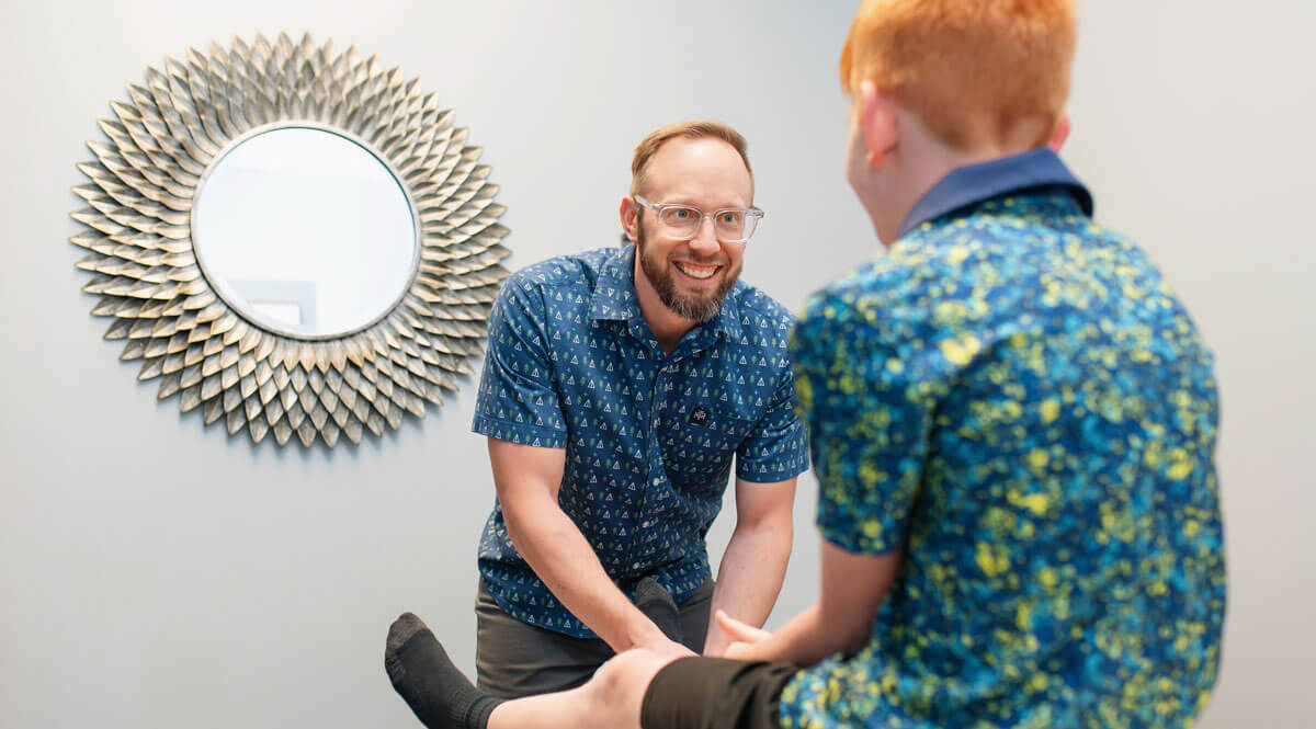 Dr. Curt with boy on adjusting table