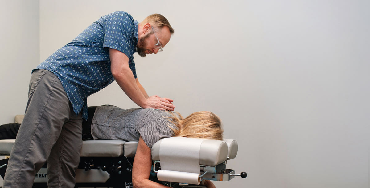 Adjusting woman's back on table
