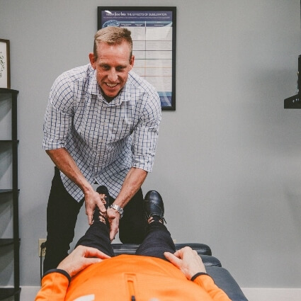 Dr Jeremy adjusting patients leg