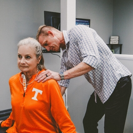 woman having back adjusted by Dr Book