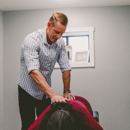 Dr Book adjusting patients back