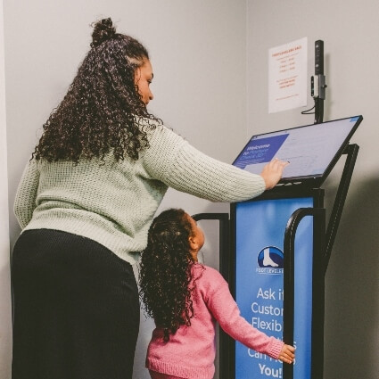 child and staff on fooT scan machine