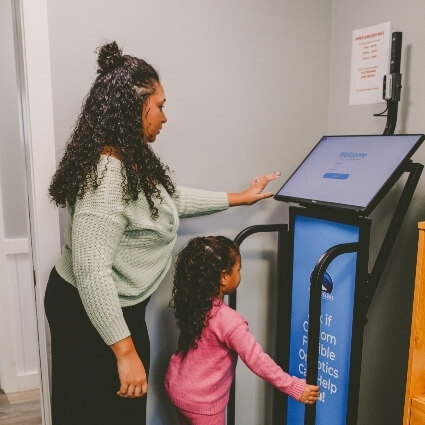 team member and child are our orthotics machine