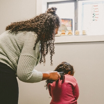 child having back scanned with a tool