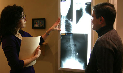 doctor showing x-rays to patient at Meadowvale Chiropractic & Massage
