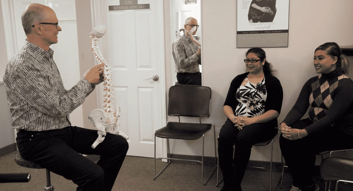 Dr. Mark Tomlin of Churchill Chiropractic in consultation with Mississauga patients