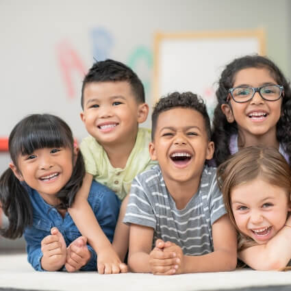 Smiling children sitting on the floor