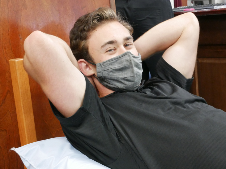 Patient laying back wearing mask