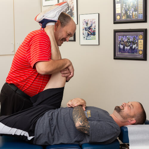 Stretching man's leg