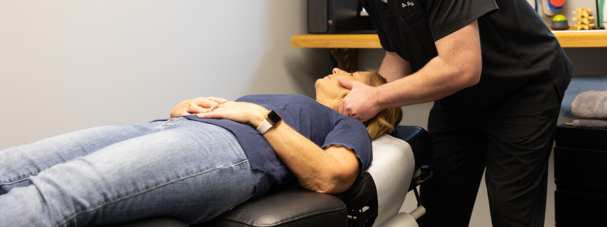 Muncie chiropractor adjusting a patient's neck