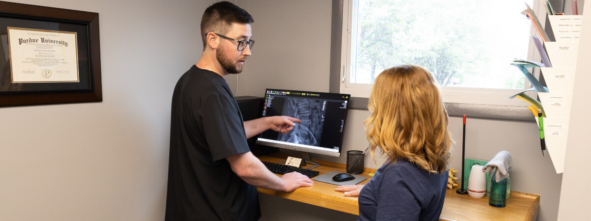 Muncie chiropractor discussing an x-ray with a patient