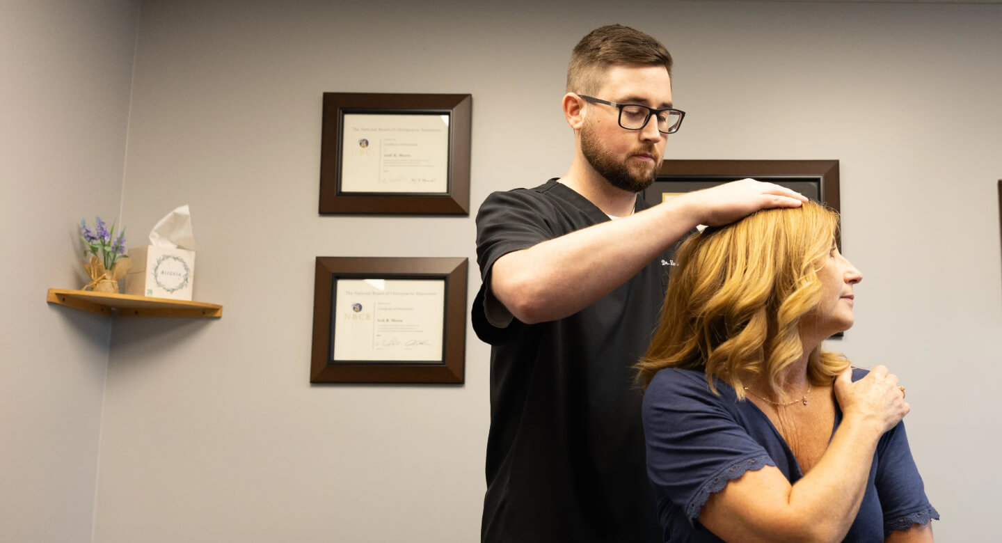 Chiropractor adjusting patient