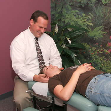 Dr Logullo adjusting patients neck
