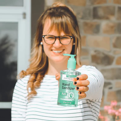 Woman holoding hand sanitizer