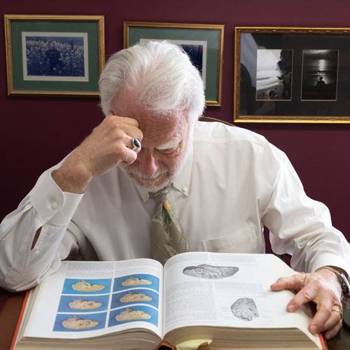 Dr. Harte looking at book