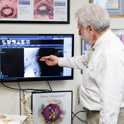 Dr. Harte pointing to computer screen