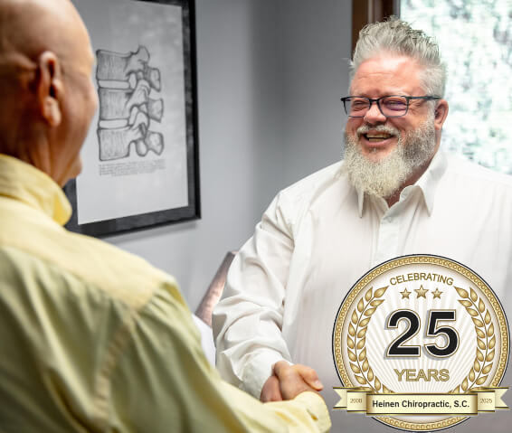 Dr. Heinen shaking hands with a patient