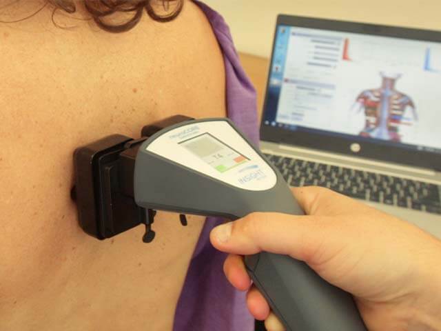 INSiGHT™ scanning tool being used on a patient's back