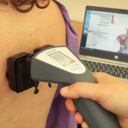 scanning a patients back with surface electromyography tool