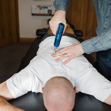 chiropractor adjusting with activator