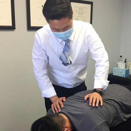 chiropractor adjusting patient's back