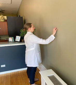 chiropractor demonstrating shoulder excercise 2