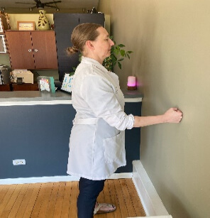 chiropractor demonstrating shoulder excercise 5