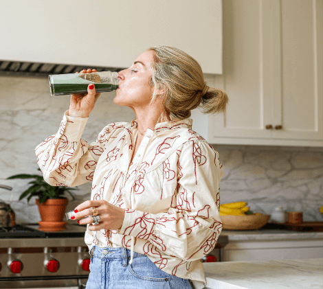 Lady drinking the green powder drink