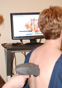 A patient being scanned with the Subluxation Station A Patient Being Scanned