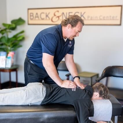 patient having back adjusted