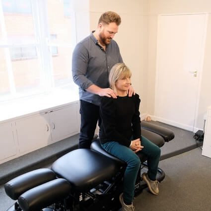 Andrew with hands on patient shoulder